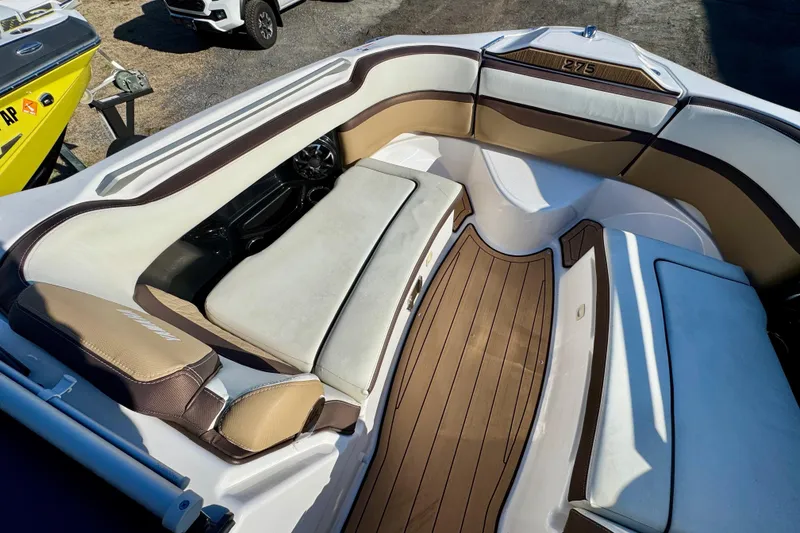 Slide: The Image of 2022 Yamaha Boats 275SD interior with cushioned seating and sleek design. - 32