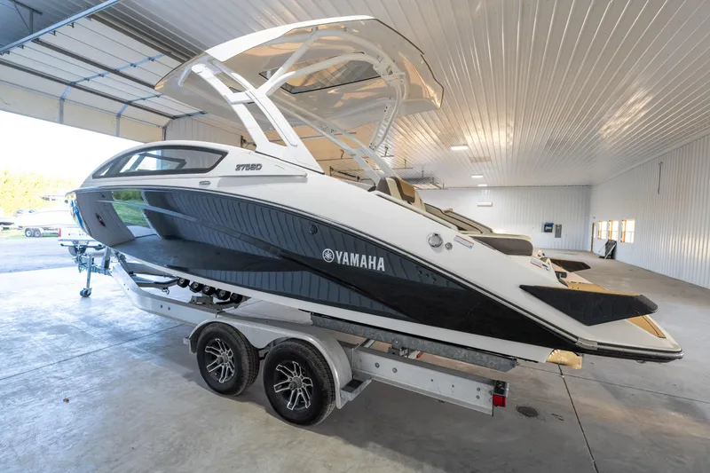 Slide: The Image of 2022 Yamaha Boats 275SD on trailer in spacious indoor storage facility. - 4