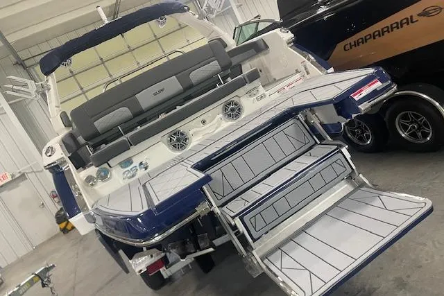 Slide: The Image of 2026 Chaparral SSX 6 boat with sleek design and spacious seating in a showroom. - 12