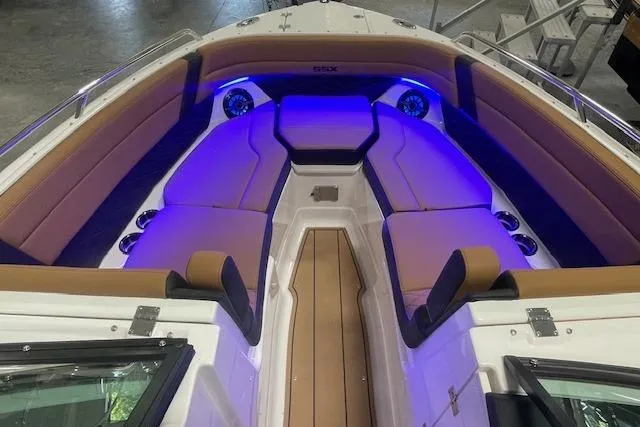 Slide: The Image of 2026 Chaparral SSX 6 boat interior with ambient blue lighting and cushioned seating. - 6