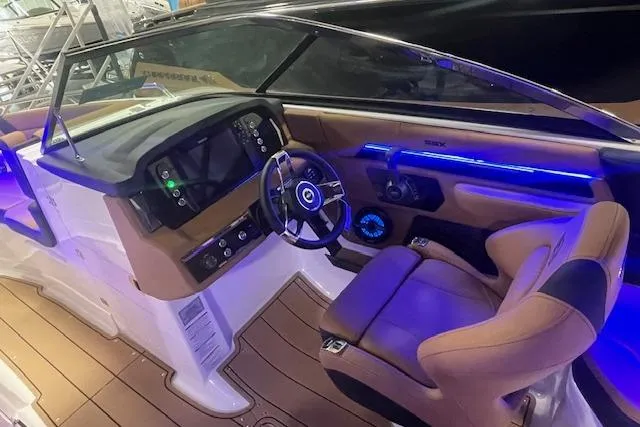 Slide: The Image of 2026 Chaparral SSX 6 boat interior with modern dashboard and luxurious seating. - 7