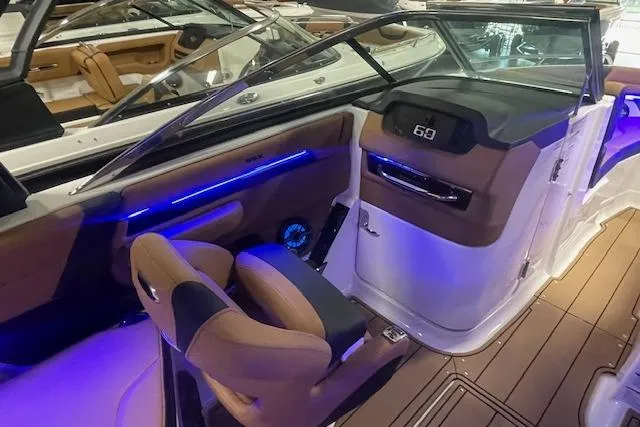 Slide: The Image of 2026 Chaparral SSX 6 boat interior with modern dashboard and ambient lighting. - 8