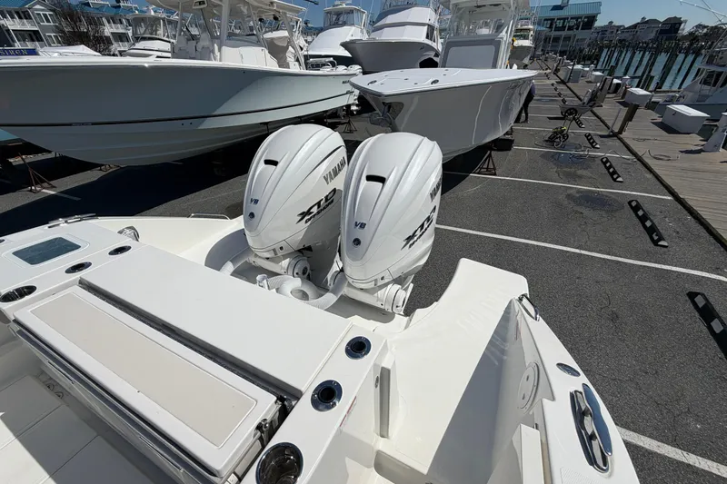 Slide: The Image of 2026 Pursuit S 358 Sport boat with twin Yamaha engines docked at a marina. - 10