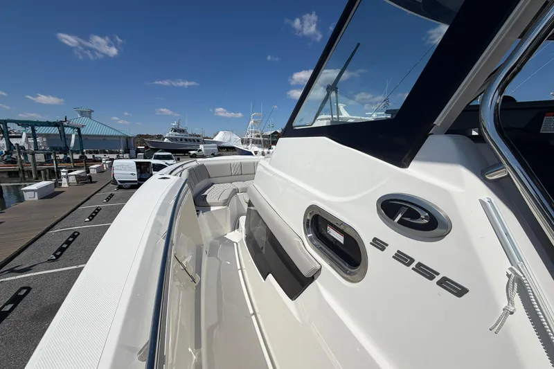 Slide: The Image of 2026 Pursuit S 358 Sport boat docked under clear blue sky. - 102