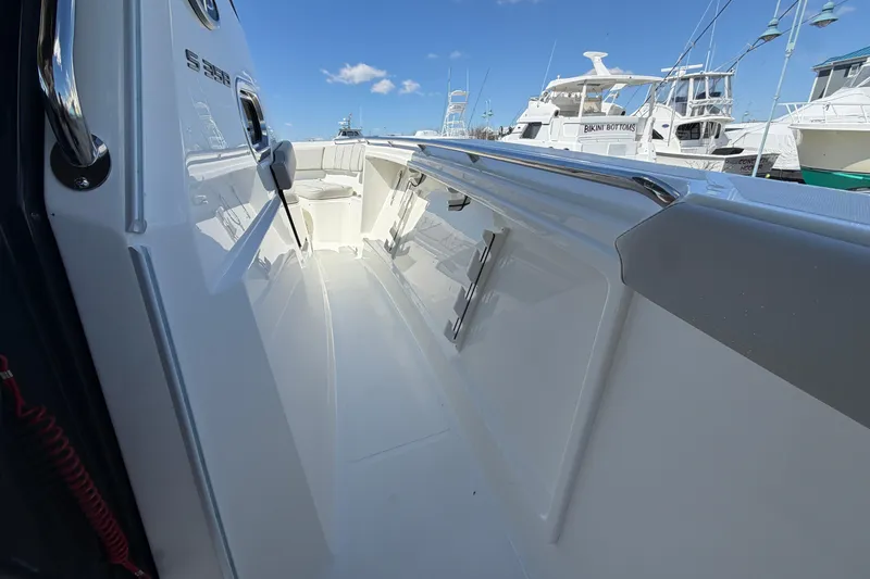Slide: The Image of 2026 Pursuit S 358 Sport boat deck with sleek design and marina view. - 103