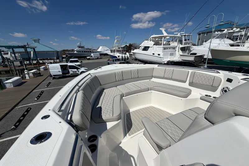 Slide: The Image of 2026 Pursuit S 358 Sport boat with luxurious seating at a marina. - 106