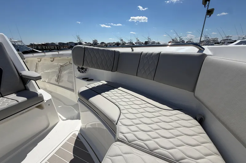 Slide: The Image of 2026 Pursuit S 358 Sport boat interior with luxurious seating and clear blue sky. - 109
