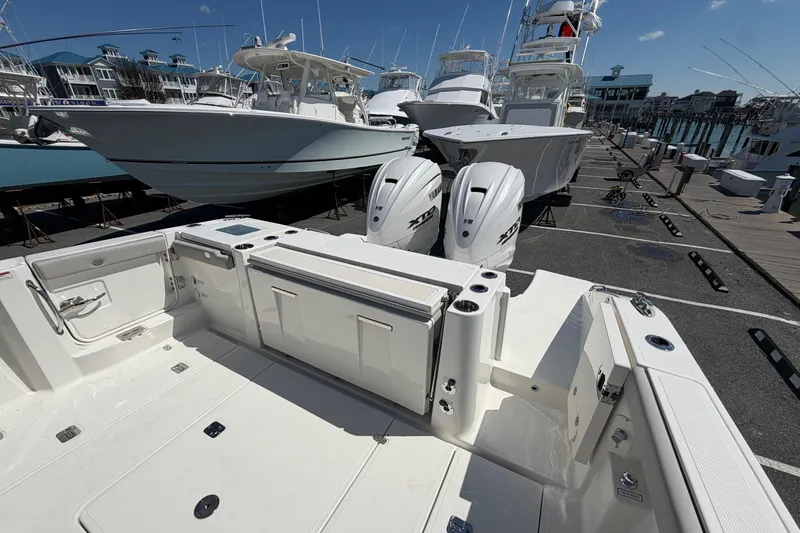 Slide: The Image of 2026 Pursuit S 358 Sport boat with dual Yamaha engines docked at marina. - 11