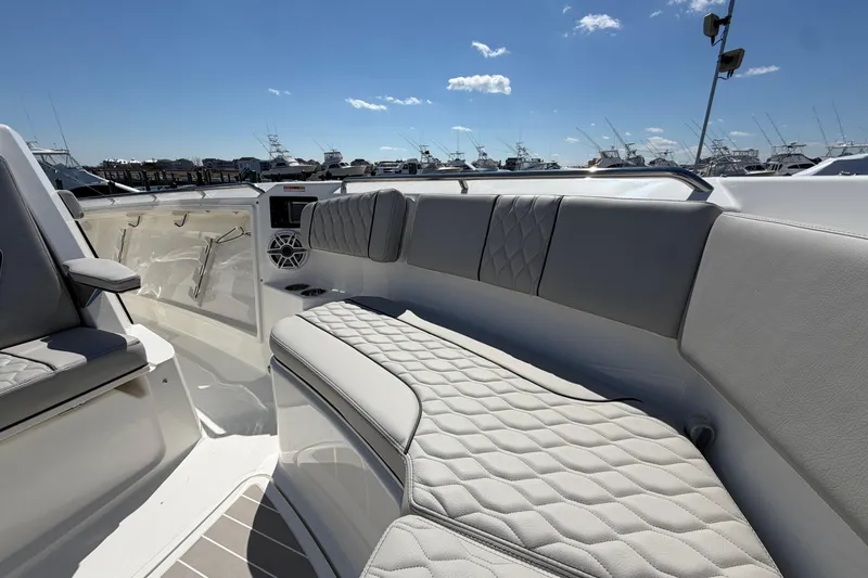 Slide: The Image of Luxurious seating on the 2026 Pursuit S 358 Sport boat under a clear blue sky. - 110
