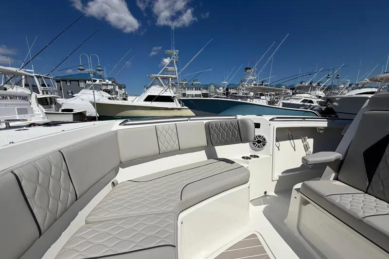 Slide: The Image of Luxurious 2026 Pursuit S 358 Sport boat interior with elegant seating at a marina. - 115