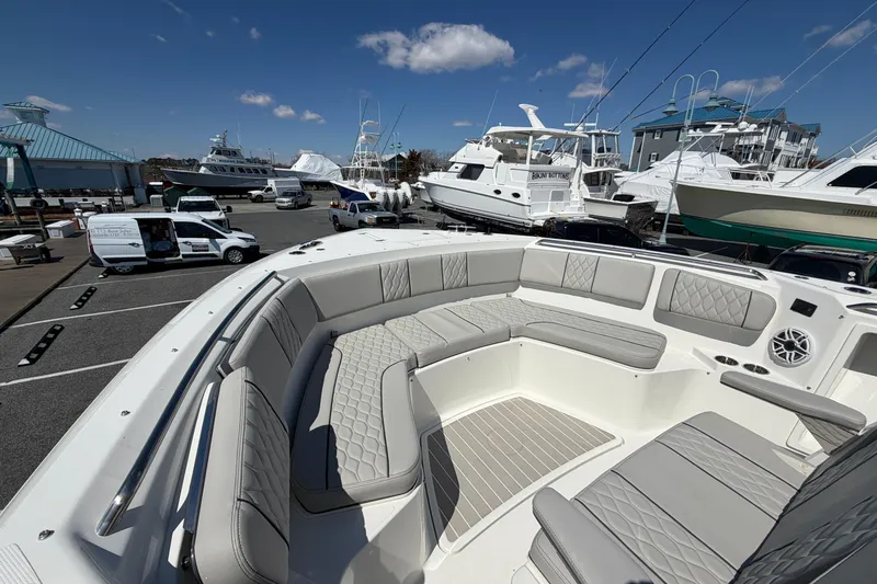 Slide: The Image of 2026 Pursuit S 358 Sport boat with luxurious seating at a marina. - 125