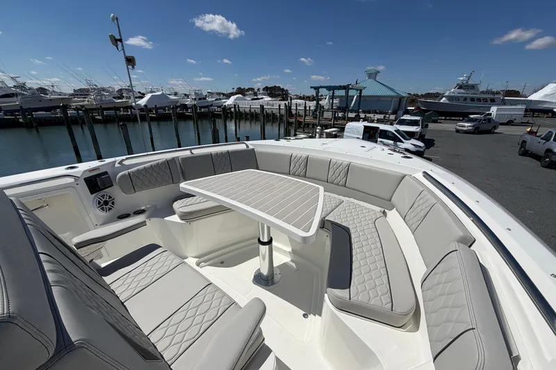 Slide: The Image of Luxurious seating area on 2026 Pursuit S 358 Sport boat, docked at marina. - 127