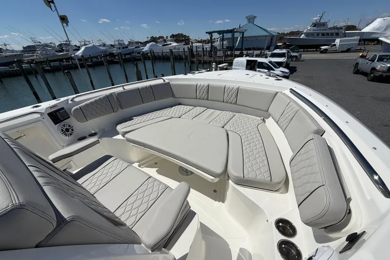 Slide: The Image of Luxurious seating area on the 2026 Pursuit S 358 Sport boat, docked at a marina. - 129