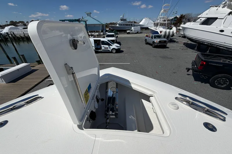 Slide: The Image of Open hatch on 2026 Pursuit S 358 Sport boat at marina, showcasing storage compartment. - 131