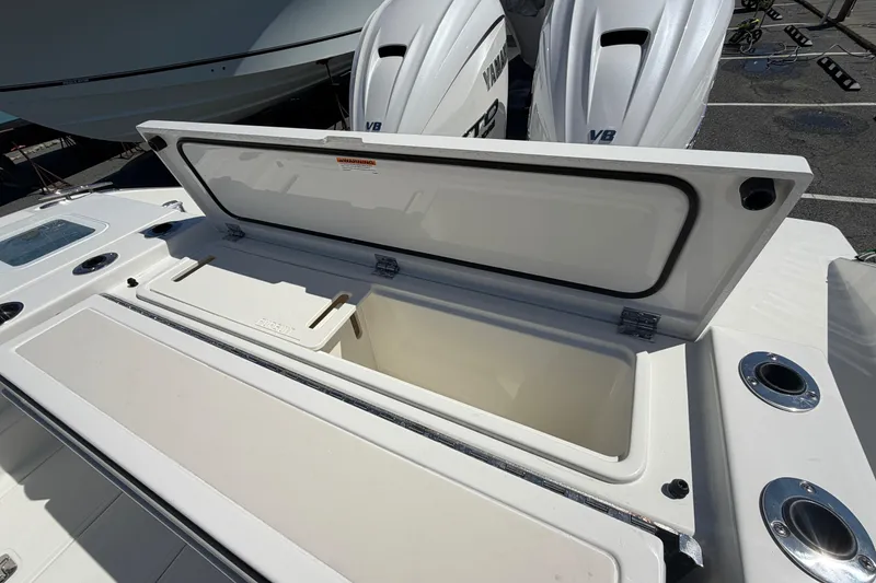 Slide: The Image of Open storage compartment on 2026 Pursuit S 358 Sport boat with twin Yamaha engines. - 15