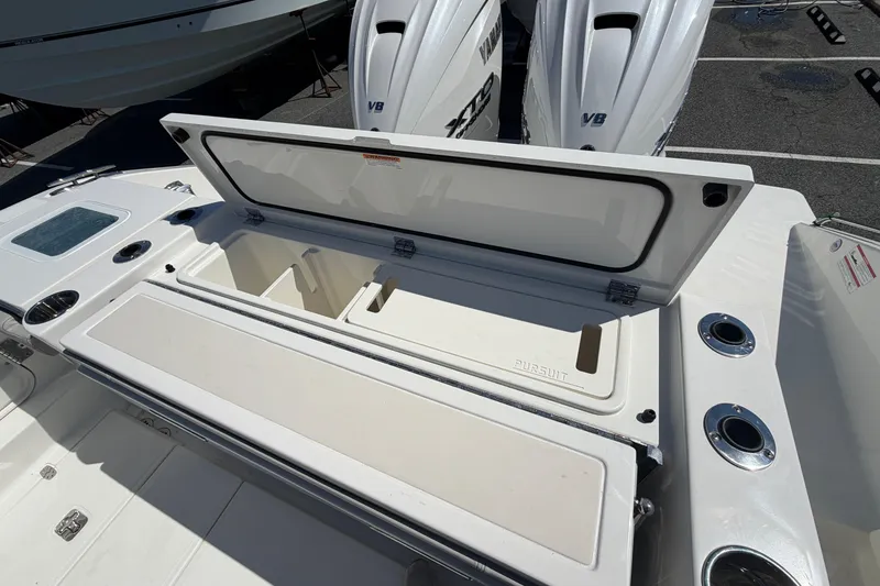 Slide: The Image of 2026 Pursuit S 358 Sport boat with open storage compartment and dual Yamaha engines. - 16