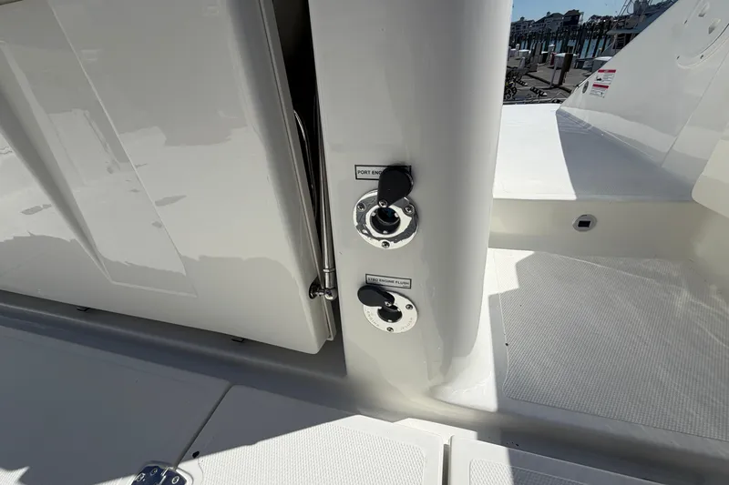 Slide: The Image of 2026 Pursuit S 358 Sport boat deck with engine flush ports. - 18