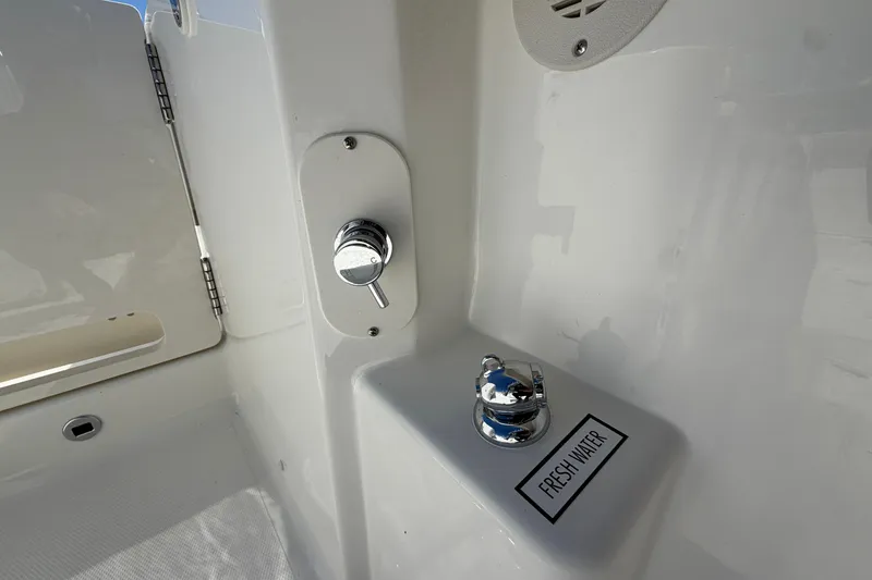 Slide: The Image of Fresh water outlet on 2026 Pursuit S 358 Sport boat, featuring chrome fixtures. - 19