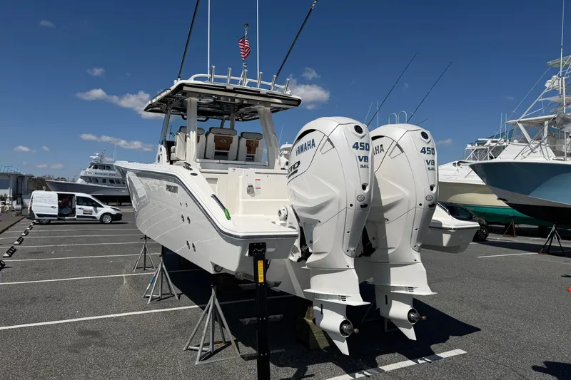 Slide: The Image of 2026 Pursuit S 358 Sport boat with twin Yamaha 450 V8 engines in a marina. - 2