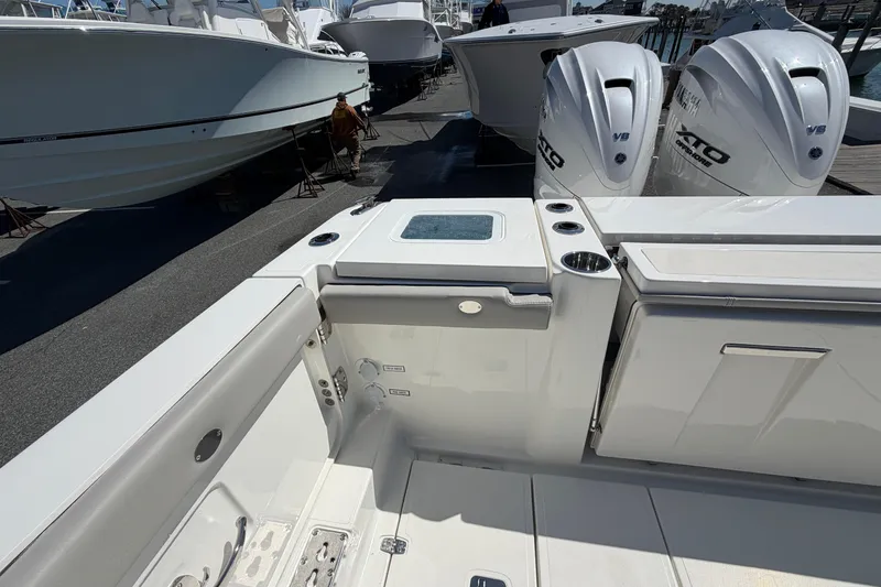 Slide: The Image of 2026 Pursuit S 358 Sport boat with twin outboard engines, docked at a marina. - 20