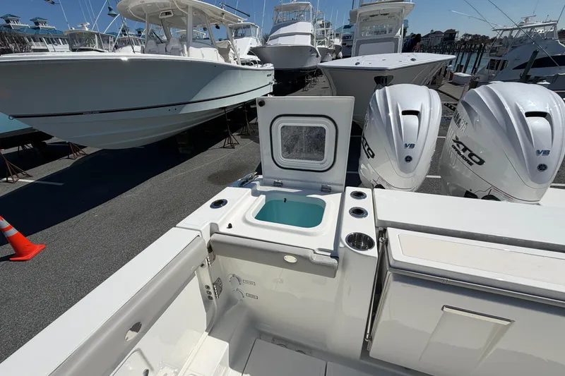 Slide: The Image of 2026 Pursuit S 358 Sport boat with dual engines and open storage compartment. - 22