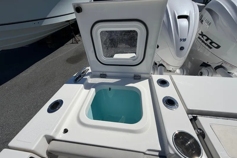 Slide: The Image of 2026 Pursuit S 358 Sport boat with open storage compartment and powerful V8 engines. - 23