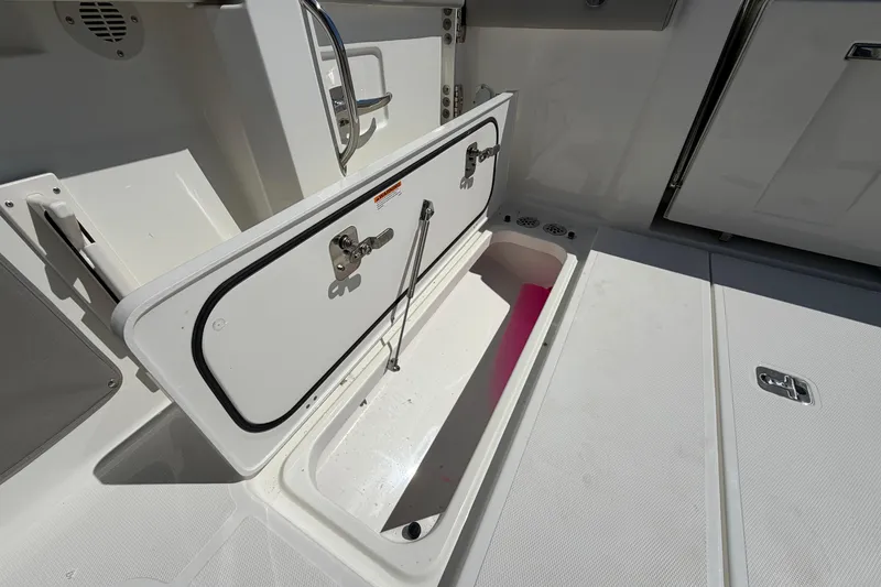 Slide: The Image of Open storage compartment on 2026 Pursuit S 358 Sport boat deck. - 27