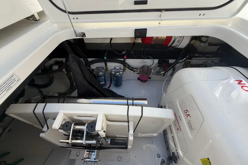 Slide: The Image of Engine compartment of 2026 Pursuit S 358 Sport boat, showcasing mechanical components and systems. - 31