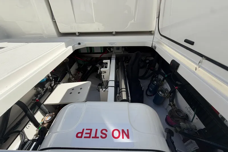 Slide: The Image of Engine compartment of 2026 Pursuit S 358 Sport boat, featuring "NO STEP" warning. - 32
