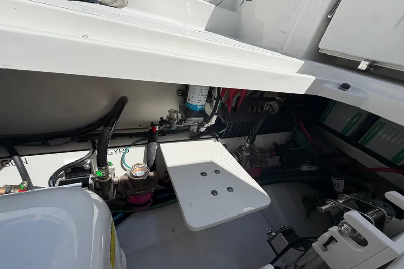 Slide: The Image of Engine compartment of 2026 Pursuit S 358 Sport boat, showcasing mechanical components and wiring. - 33