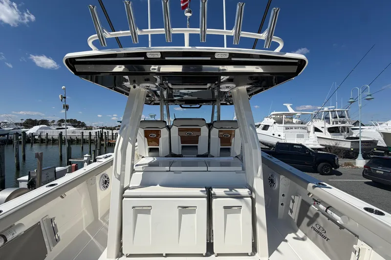 Slide: The Image of 2026 Pursuit S 358 Sport boat docked at marina under clear blue sky. - 37