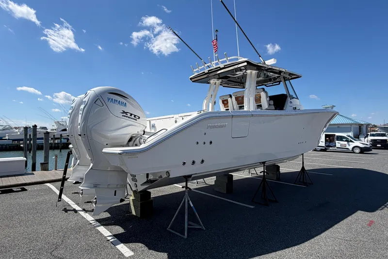 Slide: The Image of 2026 Pursuit S 358 Sport boat with Yamaha engines on display outdoors. - 4
