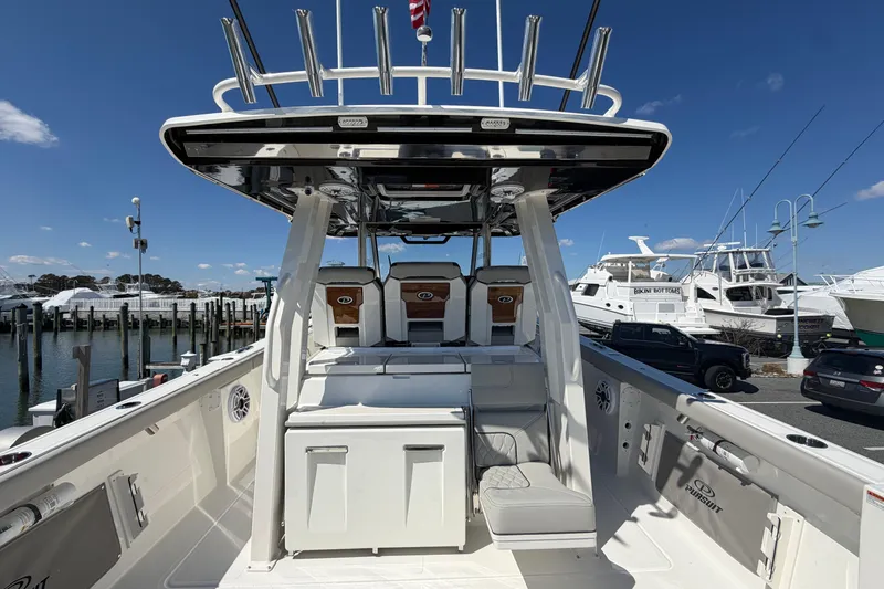 Slide: The Image of 2026 Pursuit S 358 Sport boat interior at marina, showcasing seating and helm station. - 40