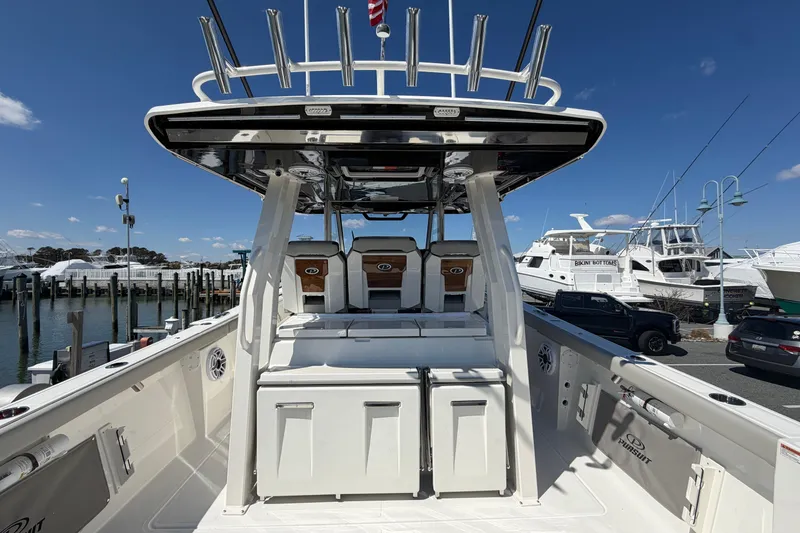 Slide: The Image of 2026 Pursuit S 358 Sport boat docked at marina, showcasing spacious deck and seating. - 41