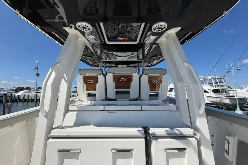Slide: The Image of 2026 Pursuit S 358 Sport boat interior with seating and modern design at a marina. - 48