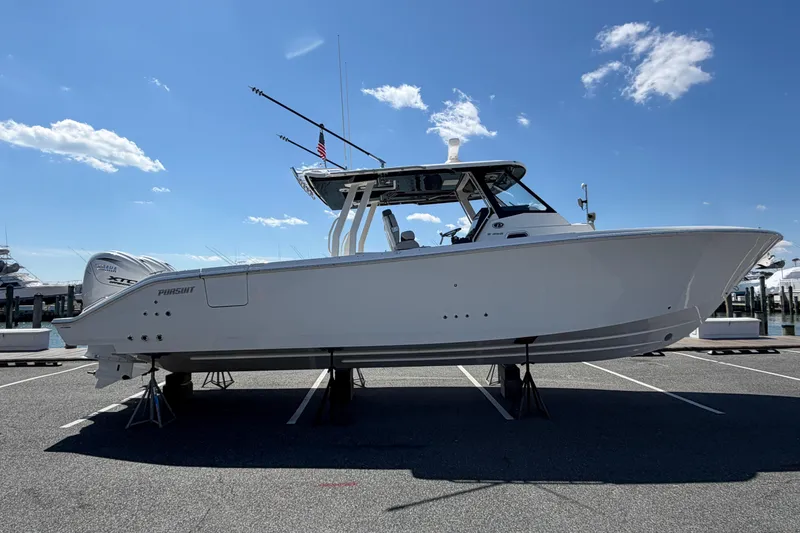 Slide: The Image of 2026 Pursuit S 358 Sport boat displayed on stands under a clear blue sky. - 5