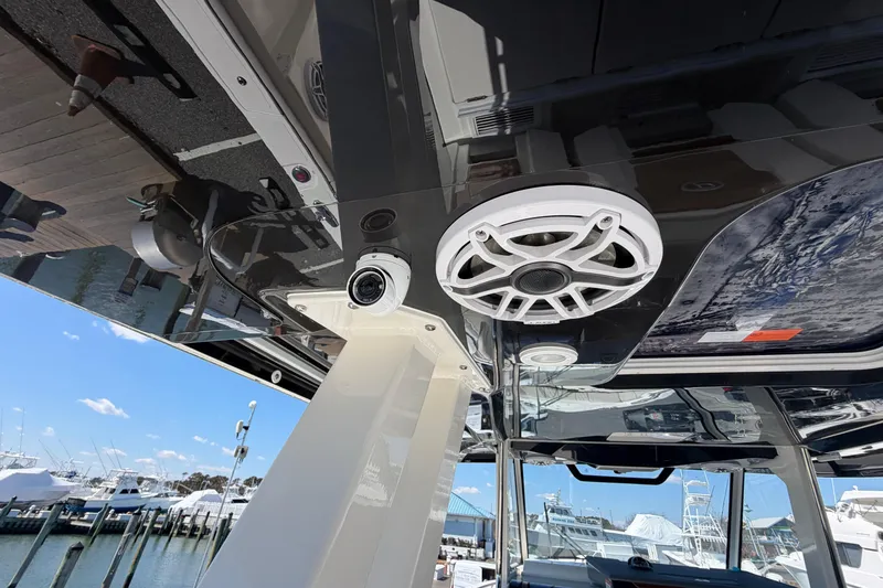 Slide: The Image of 2026 Pursuit S 358 Sport boat interior with speaker and camera, docked at marina. - 50