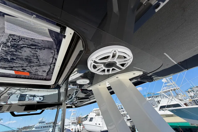 Slide: The Image of Interior view of 2026 Pursuit S 358 Sport boat with speaker and hatch detail. - 51
