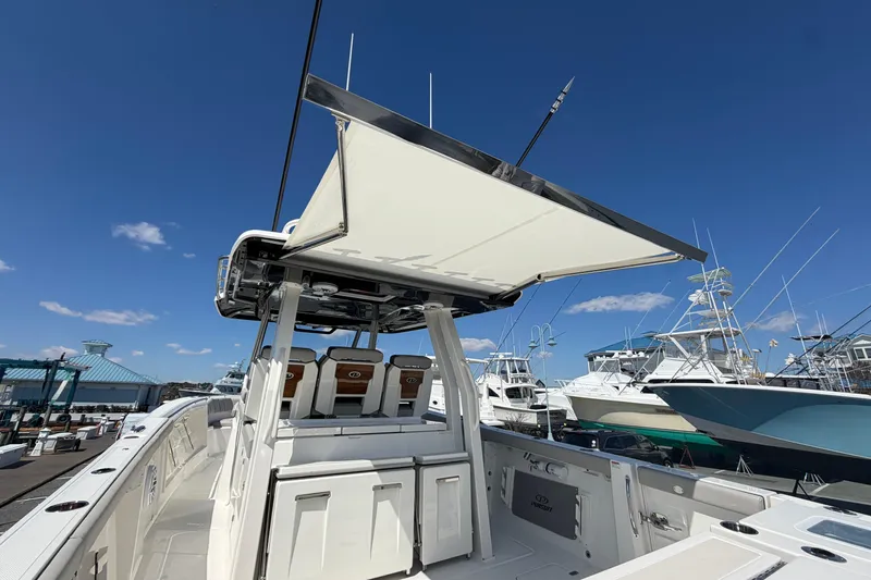 Slide: The Image of 2026 Pursuit S 358 Sport boat with sleek design and spacious deck under clear blue sky. - 52