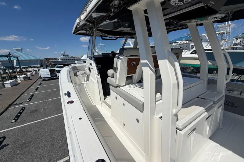 Slide: The Image of 2026 Pursuit S 358 Sport boat docked, showcasing sleek design and spacious seating. - 55