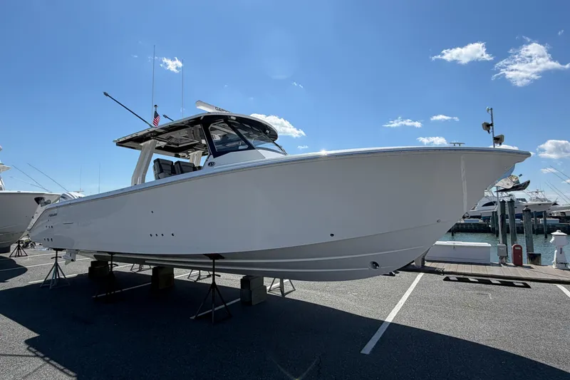 Slide: The Image of 2026 Pursuit S 358 Sport boat displayed on a marina under a clear blue sky. - 6