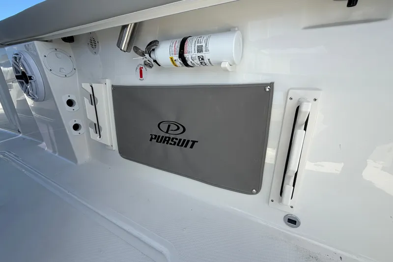 Slide: The Image of 2026 Pursuit S 358 Sport boat interior with branded storage and safety equipment. - 60