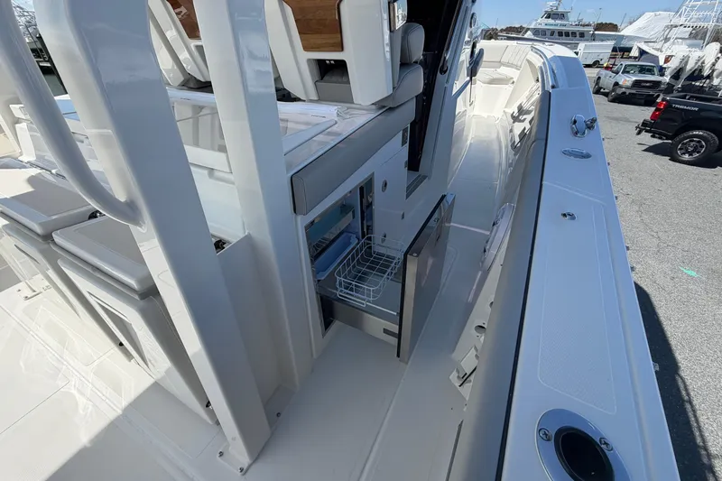 Slide: The Image of 2026 Pursuit S 358 Sport boat interior with open storage compartment and seating. - 62
