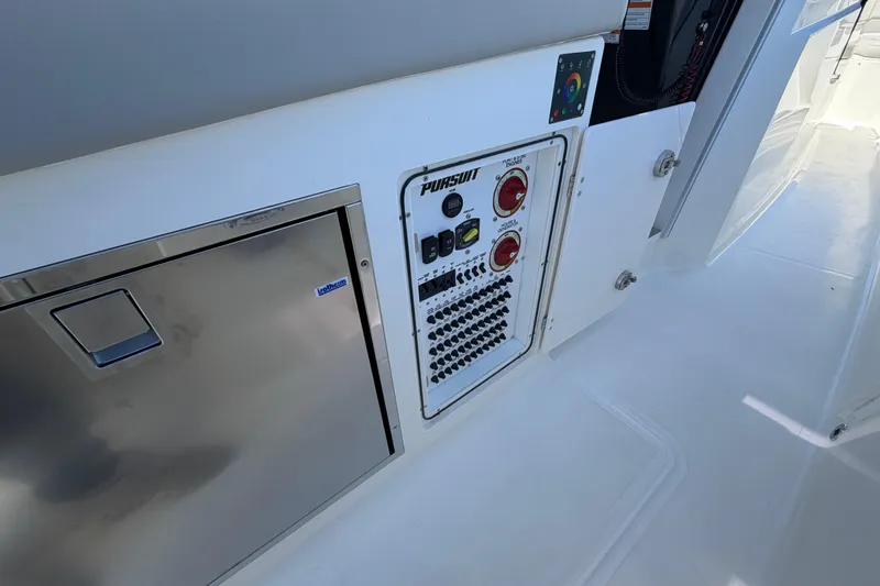 Slide: The Image of Control panel and storage on 2026 Pursuit S 358 Sport boat deck. - 64