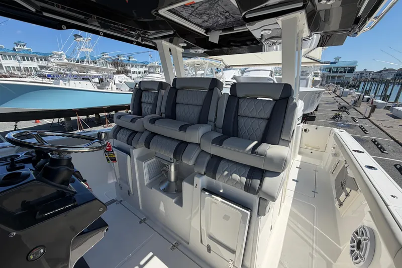 Slide: The Image of 2026 Pursuit S 358 Sport boat interior with luxurious seating and modern helm design. - 66