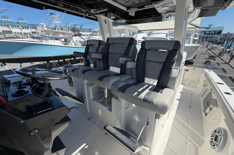 Slide: The Image of Interior view of 2026 Pursuit S 358 Sport boat with luxurious seating and steering console. - 69