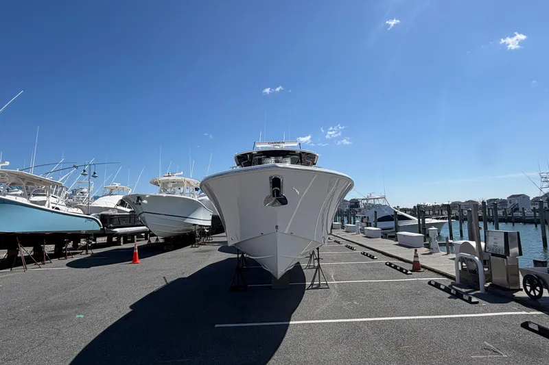 Slide: The Image of 2026 Pursuit S 358 Sport boat docked under clear blue sky. - 7
