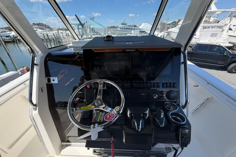 Slide: The Image of Helm of 2026 Pursuit S 358 Sport boat with modern controls and steering wheel. - 71