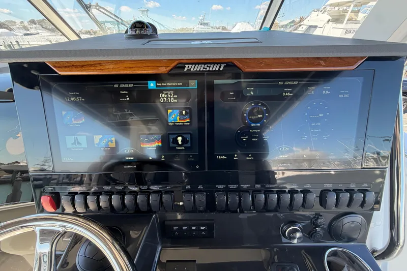 Slide: The Image of 2026 Pursuit S 358 Sport boat dashboard with advanced Garmin navigation displays. - 72