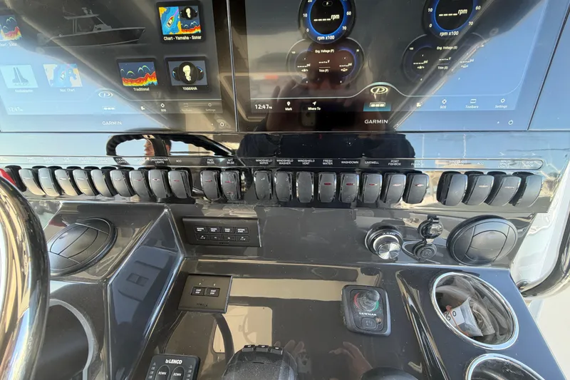 Slide: The Image of Control panel of 2026 Pursuit S 358 Sport boat with Garmin displays and switches. - 73